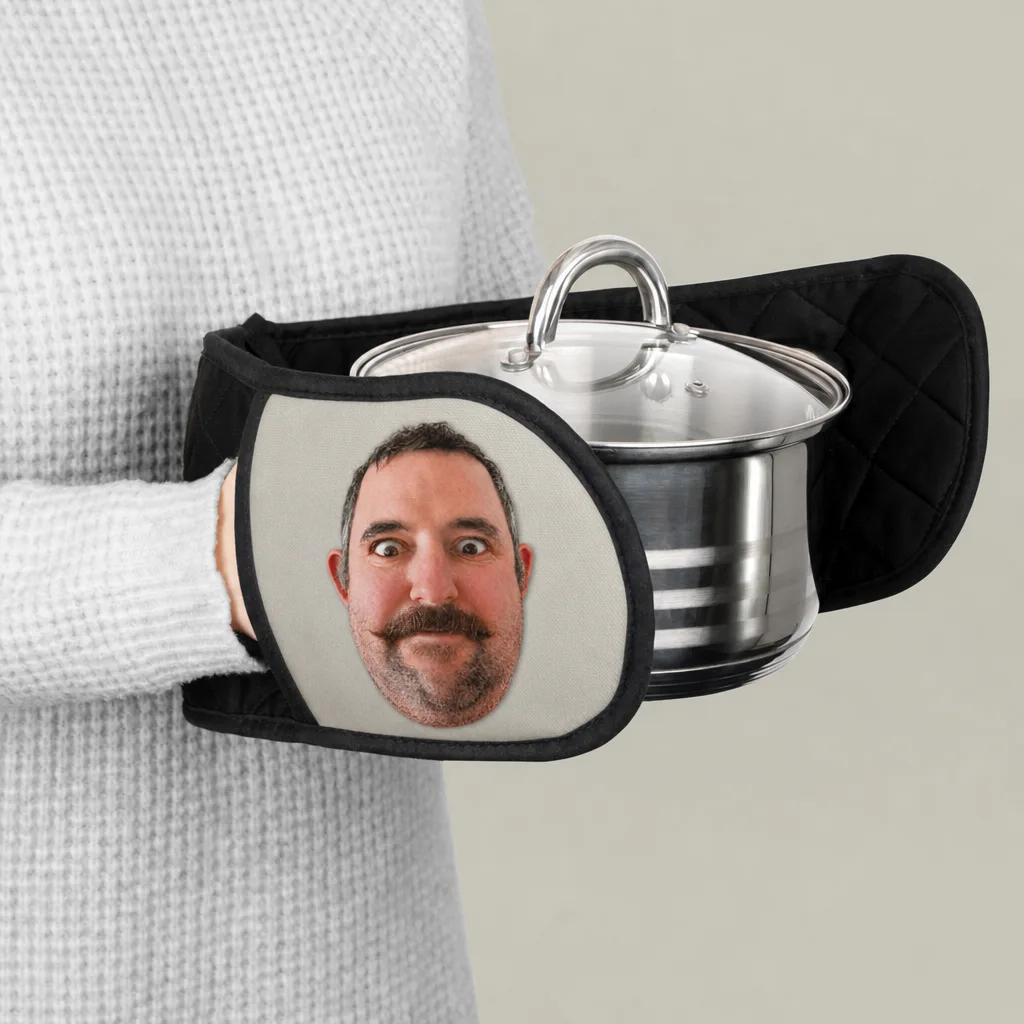 An oven mitt holding a pot, our picture printed across its outer face.